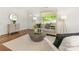 Cozy living room featuring a neutral color palette, area rug, comfortable seating, and natural light from the window at 3339 Benard Ave, Charlotte, NC 28206