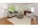 Bright living room with hardwood floors, a cozy fireplace, and large windows at 3339 Benard Ave, Charlotte, NC 28206