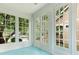 Bright sunroom featuring a turquoise floor and large windows offering picturesque views of the surrounding landscape at 3339 Benard Ave, Charlotte, NC 28206