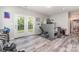 Basement with light gray wood-look flooring and access to the backyard at 3505 Mallard Cove Ct, Charlotte, NC 28269