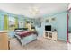 Charming bedroom featuring a ceiling fan, bright walls, and an abundance of natural light from the window at 3505 Mallard Cove Ct, Charlotte, NC 28269