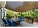 Spacious deck with a shade awning and comfortable blue seating at 3505 Mallard Cove Ct, Charlotte, NC 28269