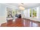 Spacious dining room with hardwood floors, blue walls with white trim and oversized windows at 3505 Mallard Cove Ct, Charlotte, NC 28269