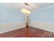 Spacious dining room with hardwood floors, blue walls with white trim and modern light fixture at 3505 Mallard Cove Ct, Charlotte, NC 28269
