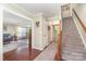 Foyer featuring hardwood floors, a staircase, and an entry to the living room at 3505 Mallard Cove Ct, Charlotte, NC 28269