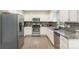 Updated kitchen features gray granite countertops, stainless appliances, and gray subway tile backsplash at 3505 Mallard Cove Ct, Charlotte, NC 28269