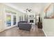 Cozy living room with fireplace, ceiling fan, and French doors to backyard at 3505 Mallard Cove Ct, Charlotte, NC 28269
