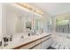 Spacious main bathroom with dual sinks, garden tub and a large window offering an abundance of natural light at 3505 Mallard Cove Ct, Charlotte, NC 28269