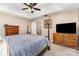 Comfortable main bedroom with ceiling fan, large dressers and easy access to the ensuite bathroom at 3505 Mallard Cove Ct, Charlotte, NC 28269