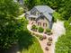 Aerial view of a brick home with mature landscaping, a driveway, and a well-manicured lawn at 3735 Gordon St, Terrell, NC 28682