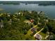 Stunning aerial view of the property, nestled among lush trees and overlooking the serene lake at 3735 Gordon St, Terrell, NC 28682