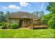 Inviting backyard showcasing the brick home, a wooden deck, and mature landscaping at 3735 Gordon St, Terrell, NC 28682