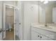 Well-lit half bath with a white vanity, mirror, and a view of the toilet in a separate room at 3735 Gordon St, Terrell, NC 28682