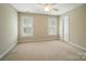Bright bedroom with neutral carpet, a ceiling fan, plantation shutters, and a closet at 3735 Gordon St, Terrell, NC 28682