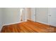Spacious bedroom with hardwood floors and neutral walls, featuring entrances to the bathroom and hallway at 3735 Gordon St, Terrell, NC 28682