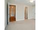 Neutral bedroom offering multiple entry points and bright light from an adjacent bathroom at 3735 Gordon St, Terrell, NC 28682