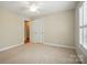 Neutral bedroom with plush carpeting, a ceiling fan, and natural light streaming through shuttered windows at 3735 Gordon St, Terrell, NC 28682