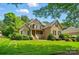 Charming brick home with a manicured lawn, mature trees, and inviting front porch at 3735 Gordon St, Terrell, NC 28682
