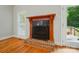 Cozy fireplace with brick hearth, a wooden mantel, and a decorative fire screen at 3735 Gordon St, Terrell, NC 28682