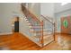 Elegant foyer with hardwood floors and a staircase featuring decorative wrought iron railings and wood steps at 3735 Gordon St, Terrell, NC 28682