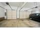 Spacious two-car garage with high ceilings, automatic doors, and a black car parked inside at 3735 Gordon St, Terrell, NC 28682