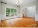 Bright living room with large window offering backyard views, complemented by hardwood floors and elegant trim at 3735 Gordon St, Terrell, NC 28682