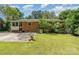 This backyard features a brick house and a large lawn at 3939 Sheffield Dr, Charlotte, NC 28205
