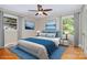 This bedroom features a large window with a ceiling fan, hardwood floors, and plenty of natural light at 3939 Sheffield Dr, Charlotte, NC 28205