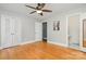 The bedroom features hardwood floors, white trim, and an attached bathroom and closet space at 3939 Sheffield Dr, Charlotte, NC 28205