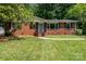 Classic brick home with a neat front yard and inviting front entrance at 3939 Sheffield Dr, Charlotte, NC 28205
