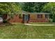 Charming brick home with well-maintained lawn, trimmed shrubbery, and classic black shutters at 3939 Sheffield Dr, Charlotte, NC 28205