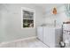 This laundry room features tile floors, a laundry sink, and a window at 3939 Sheffield Dr, Charlotte, NC 28205