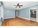 Spacious living area with hardwood floors, ceiling fan and neutral wall color at 3939 Sheffield Dr, Charlotte, NC 28205