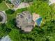 Aerial view of estate showing house, pool, patio, and surrounding trees at 4001 Doves Roost Ct, Charlotte, NC 28211