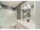 Modern bathroom with a glass shower, a large mirror reflecting the space, and clean white fixtures at 4001 Doves Roost Ct, Charlotte, NC 28211