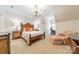 Elegant bedroom featuring a wood-trimmed bed, decorative lighting, and a cozy sitting area with a view at 4001 Doves Roost Ct, Charlotte, NC 28211