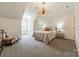 Bright bedroom with decorative lighting, patterned carpet and an ornate chair at 4001 Doves Roost Ct, Charlotte, NC 28211