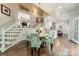 Light-filled dining area adjacent to kitchen features hardwood floors, seating for four, and backyard access at 4001 Doves Roost Ct, Charlotte, NC 28211