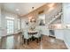 Open dining area with a modern chandelier, adjacent to the staircase and featuring an in-built wine cooler at 4001 Doves Roost Ct, Charlotte, NC 28211