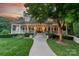 Charming home with a well-maintained lawn, stone walkway, and inviting covered porch at 4001 Doves Roost Ct, Charlotte, NC 28211