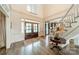 Elegant foyer with a grand staircase, hardwood floors, and a double-door entrance at 4001 Doves Roost Ct, Charlotte, NC 28211