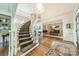 Spacious foyer with a curved staircase, hardwood floors, chandelier, and open access to other rooms at 4001 Doves Roost Ct, Charlotte, NC 28211