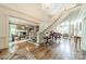 Bright foyer featuring a staircase, chandelier, hardwood floors, and access to living areas at 4001 Doves Roost Ct, Charlotte, NC 28211