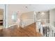 Bright hallway with hardwood floors, white railings, and elegant chandelier at 4001 Doves Roost Ct, Charlotte, NC 28211