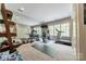 Well-lit home gym with ample workout equipment, mirrors, and natural light from the windows at 4001 Doves Roost Ct, Charlotte, NC 28211