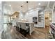 Open kitchen featuring a large center island with seating, custom cabinetry, and modern stainless steel appliances at 4001 Doves Roost Ct, Charlotte, NC 28211