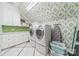 Spacious laundry room with modern appliances, green-tiled backsplash, and ample storage space at 4001 Doves Roost Ct, Charlotte, NC 28211