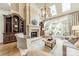 Bright living room featuring a stone fireplace, high ceilings, and french doors that let in plenty of light at 4001 Doves Roost Ct, Charlotte, NC 28211