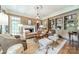 Inviting living room features a fireplace, neutral decor, built-in shelves, and lots of sunlight at 4001 Doves Roost Ct, Charlotte, NC 28211