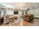 Cozy living room with custom built-ins, a large window seat, hardwood floors, and a comfortable seating area at 4001 Doves Roost Ct, Charlotte, NC 28211